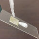 A drop of shampoo slides off a piece of plastic treated with the new coating. (Image: Ohio State University)